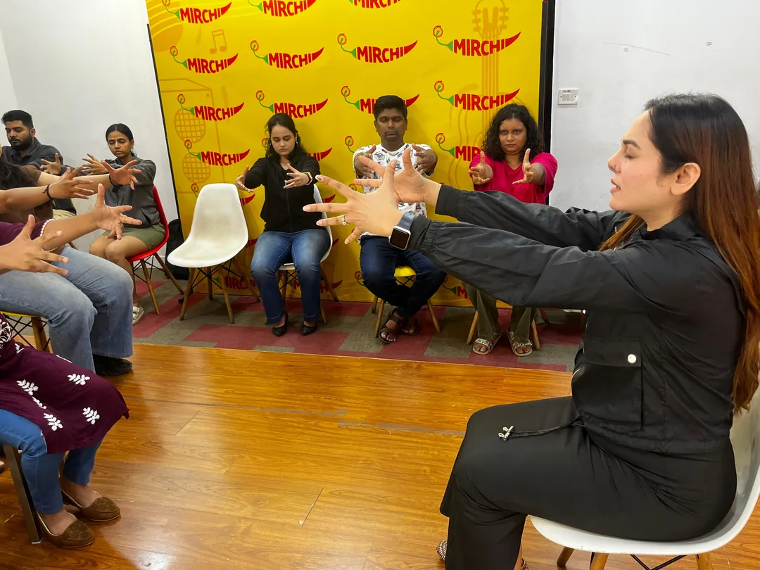 Vibha Jain guiding a group hypnotherapy demonstration session with participants seated in a semicircle
